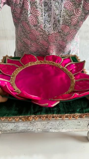 Close-up of a magenta lotus mat with gold gota trim
